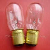 Close-up view of two 120V 15W miniature bulbs with BA15D base and T22x53 size on a red background